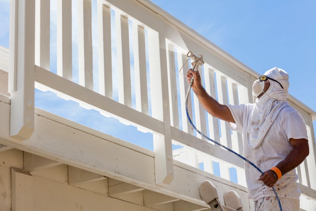 Professional painter spray painting deck railing in Cuyahoga Falls Ohio